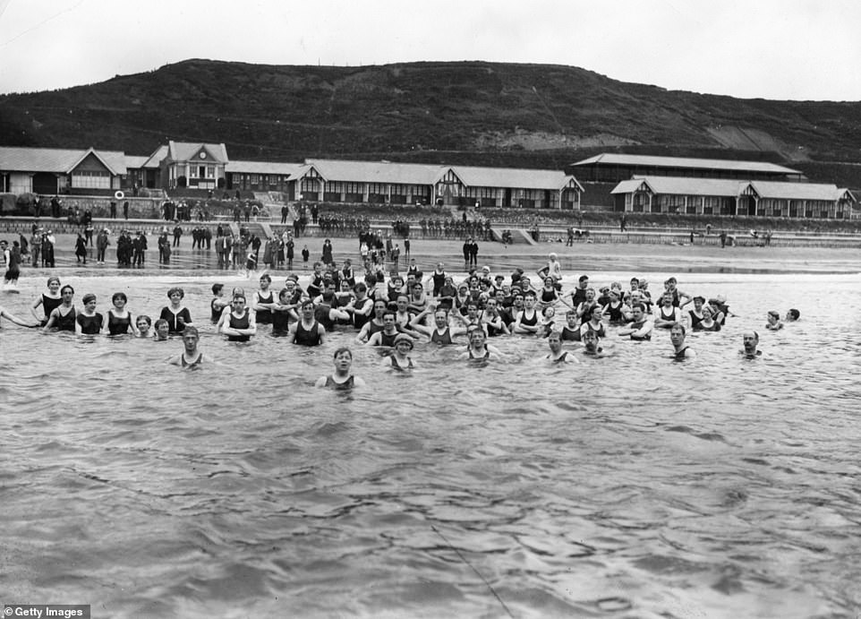 Купальщицы в море на пляже Норт-Сэндс в Скарборо в 1914 году. Еще с начала 17 века Скарборо считался «местом, где приятно отдыхать». "возьми воды"', сообщает BBC